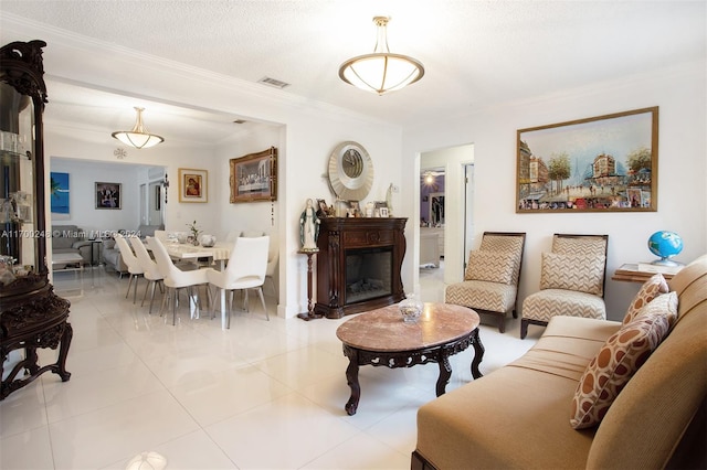 living room with crown molding, light tile patterned floors, and a textured ceiling