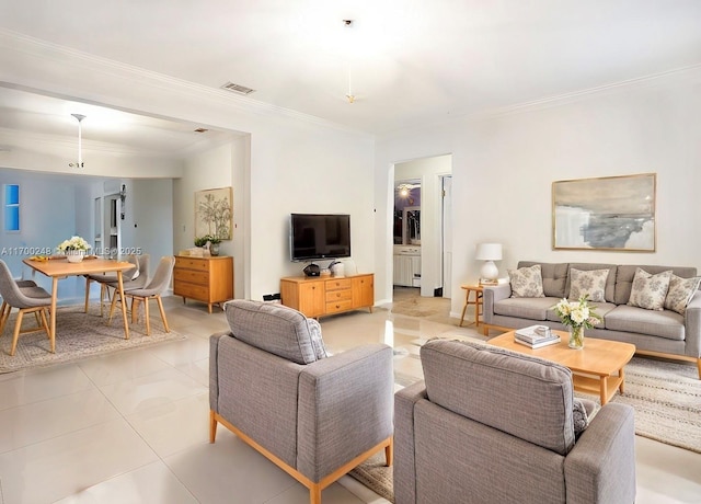 living room featuring visible vents, crown molding, and light tile patterned flooring