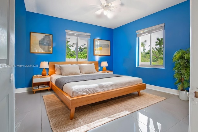 bedroom featuring tile patterned flooring, multiple windows, and baseboards