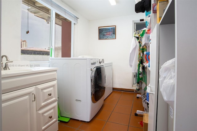 washroom with tile patterned flooring, laundry area, a sink, and washer and clothes dryer