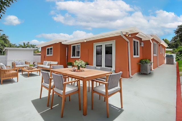 rear view of property featuring a patio, fence, outdoor dining area, french doors, and an outdoor living space