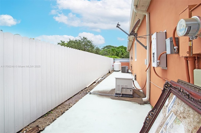 view of patio / terrace with fence and central AC unit