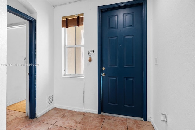 entryway with light tile patterned floors