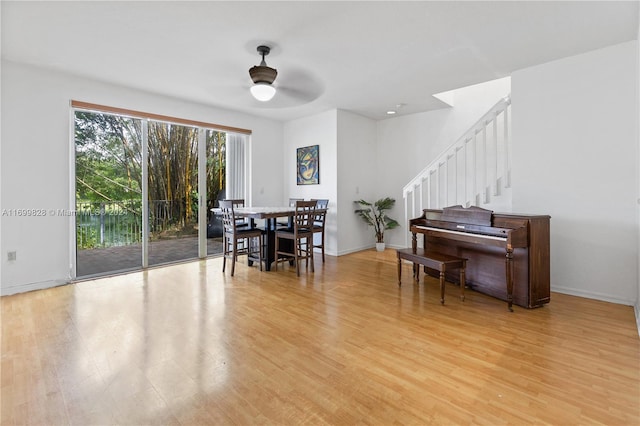 dining space featuring light wood-type flooring and ceiling fan