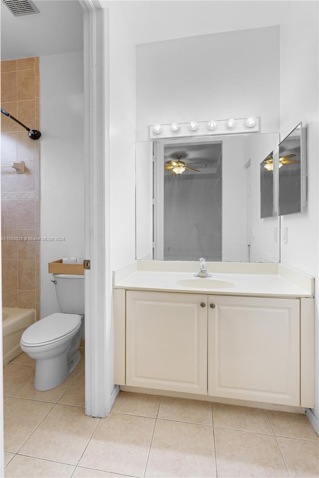 full bathroom featuring vanity, tile patterned floors, tiled shower / bath, ceiling fan, and toilet