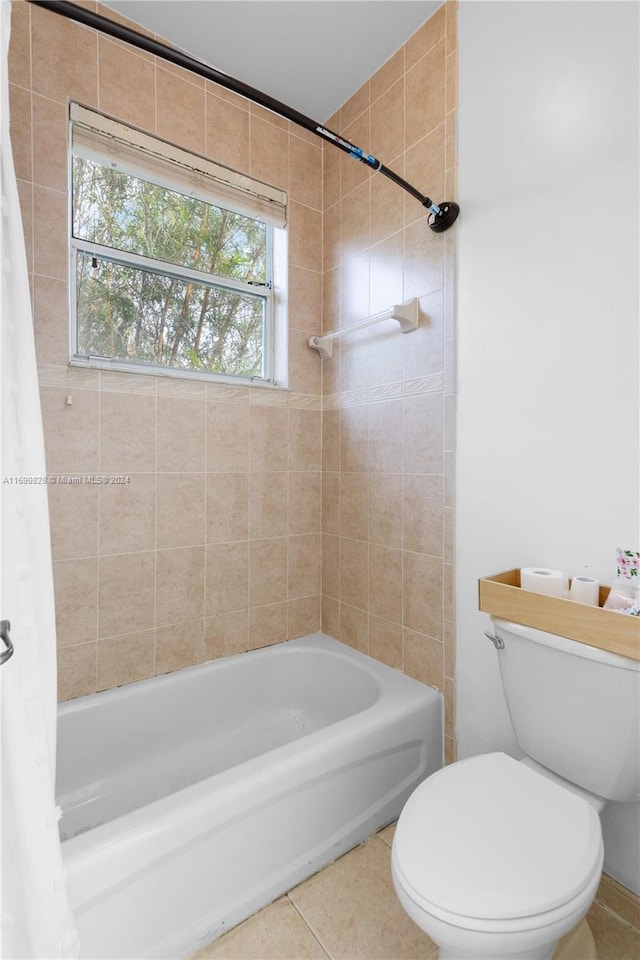 bathroom with tile patterned floors, shower / bath combo, and toilet