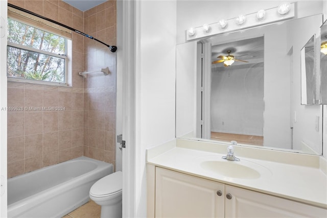 full bathroom featuring vanity, tiled shower / bath combo, and toilet