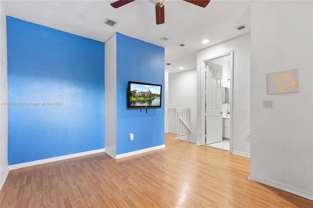 empty room with light wood-type flooring and ceiling fan