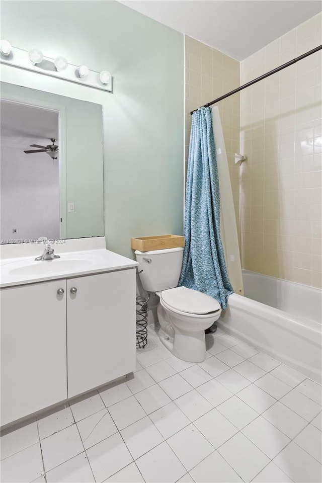 full bathroom with vanity, shower / bath combination with curtain, tile patterned flooring, ceiling fan, and toilet