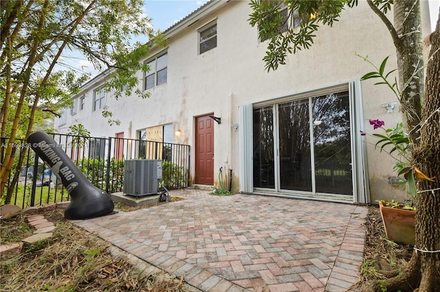 back of house with a patio and central AC unit