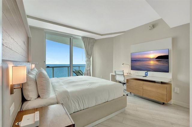 bedroom with access to outside and light hardwood / wood-style flooring