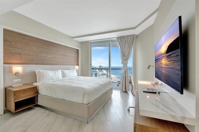 bedroom with access to exterior and light wood-type flooring