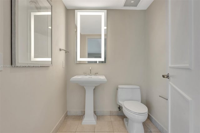 bathroom with tile patterned floors and toilet