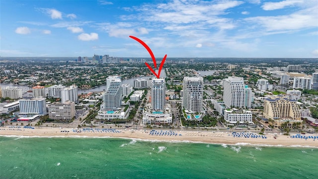 birds eye view of property featuring a view of the beach and a water view