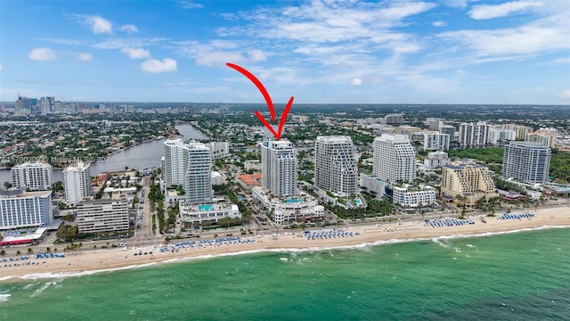 birds eye view of property featuring a water view and a view of the beach