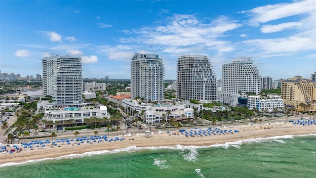 view of city featuring a beach view and a water view