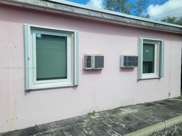 view of property exterior featuring a wall mounted AC