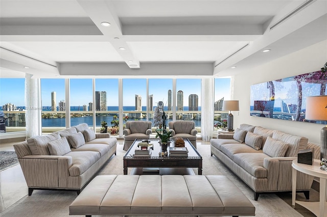 living room featuring beamed ceiling, a water view, and a wealth of natural light