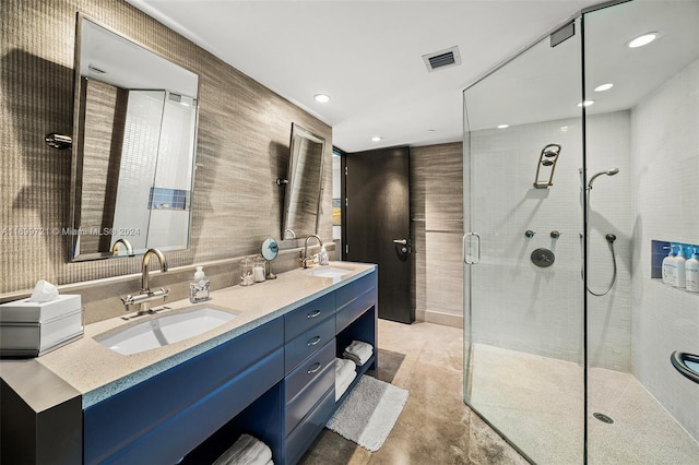 bathroom featuring vanity and a shower with door