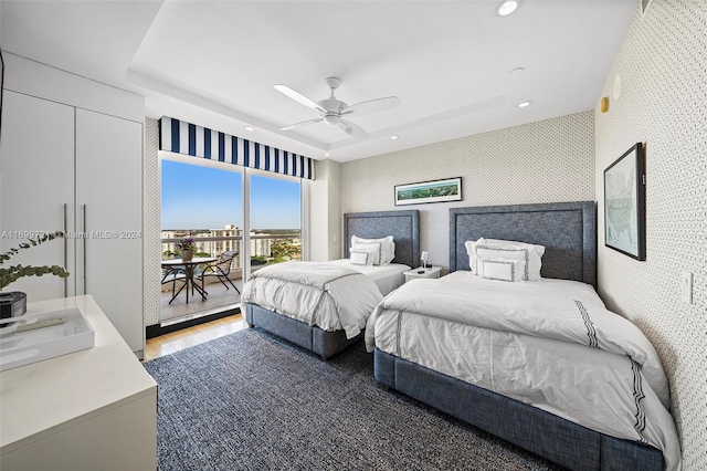 bedroom featuring hardwood / wood-style floors, access to outside, and ceiling fan