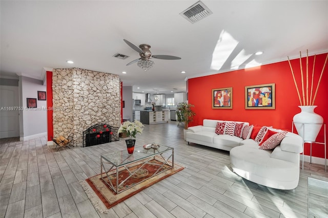 living room featuring crown molding, hardwood / wood-style floors, and ceiling fan