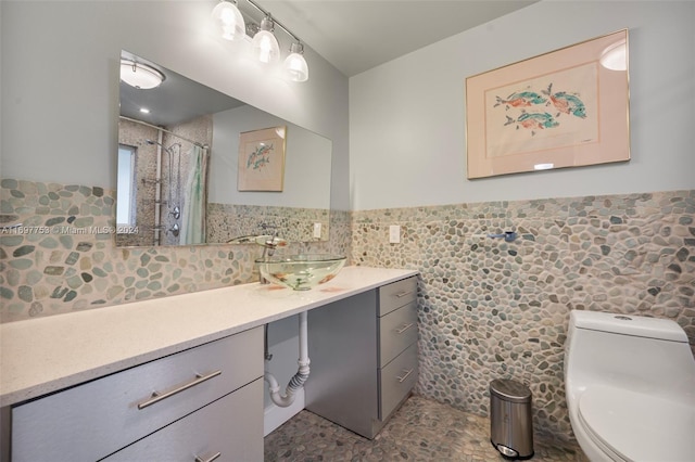 bathroom featuring a shower with curtain, vanity, tile walls, and toilet