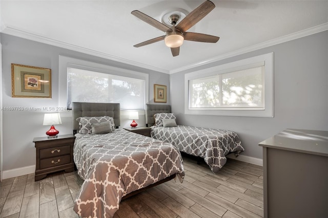 bedroom with ceiling fan, ornamental molding, and light wood-type flooring