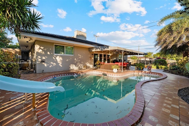 view of swimming pool featuring a patio and a water slide