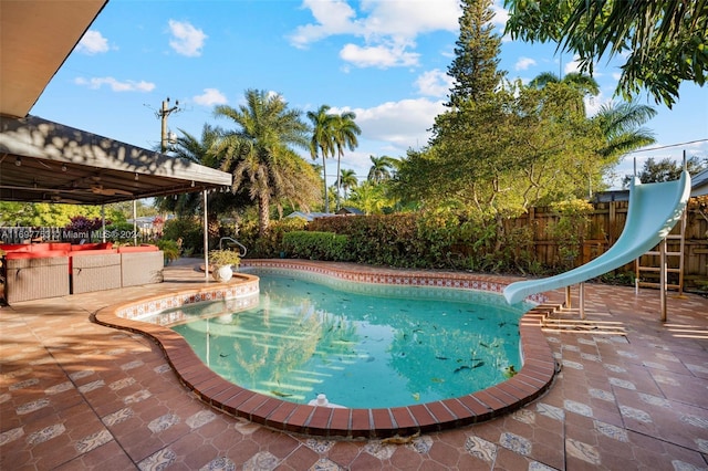 view of pool with a patio area and a water slide