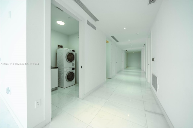 hallway with stacked washer and dryer