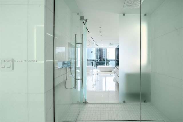 bathroom with tile patterned flooring and a shower with door