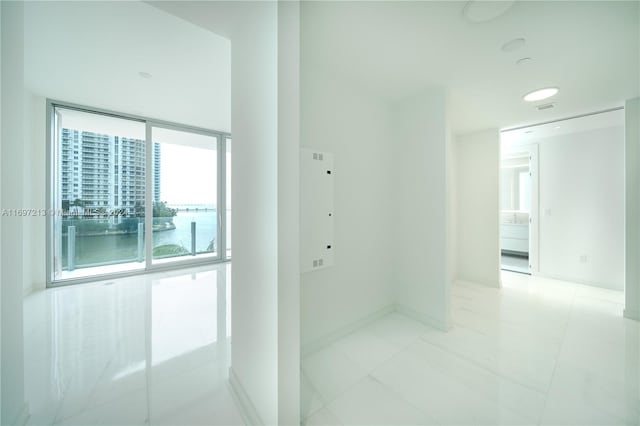 hall with a water view and light tile patterned floors