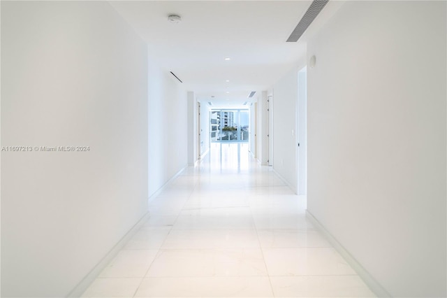 hall with light tile patterned floors