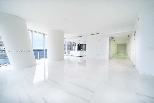 unfurnished living room with a wall of windows