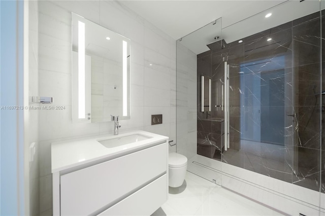 bathroom featuring tiled shower, vanity, tile walls, and toilet