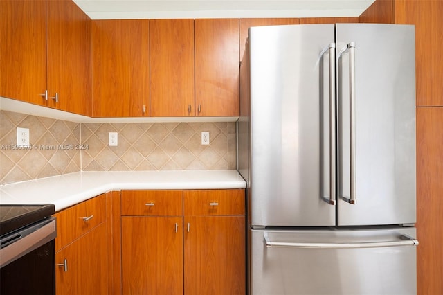 kitchen with tasteful backsplash and appliances with stainless steel finishes