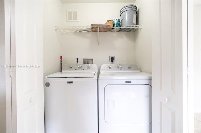 clothes washing area featuring washer and clothes dryer