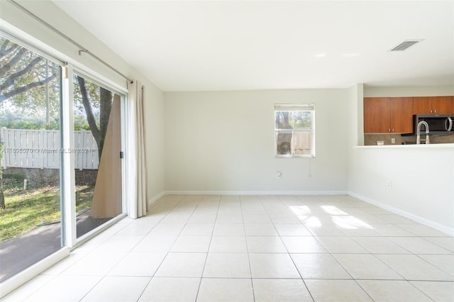 unfurnished room with light tile patterned flooring