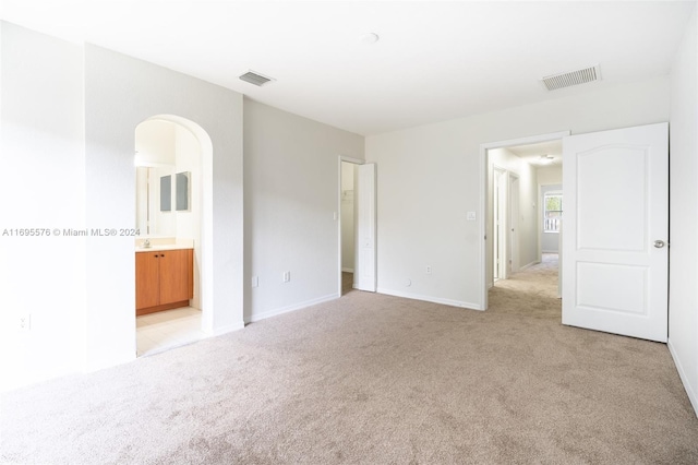 empty room with light colored carpet