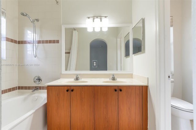 full bathroom with shower / bath combo, vanity, and toilet