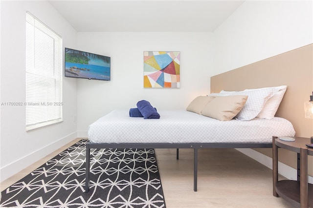 bedroom with wood-type flooring