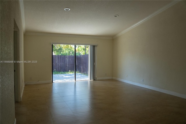 empty room featuring baseboards and crown molding