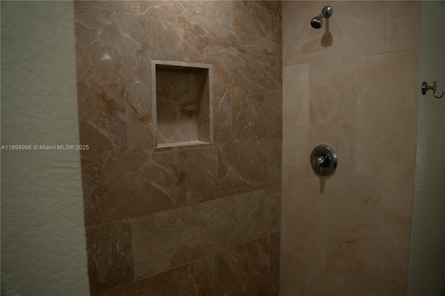 interior details with a tile shower