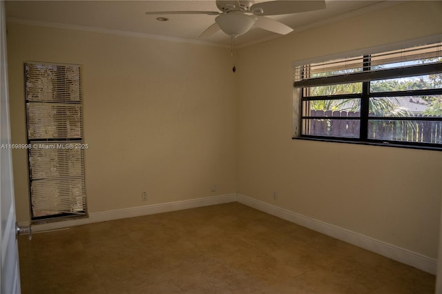 spare room with ceiling fan, crown molding, and baseboards