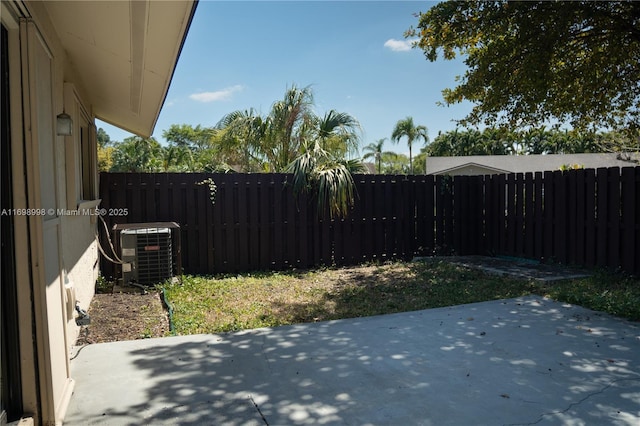 view of yard featuring cooling unit, a patio area, and a fenced backyard