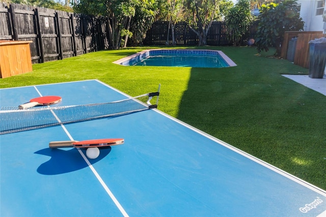 exterior space featuring a fenced in pool, a fenced backyard, and a lawn