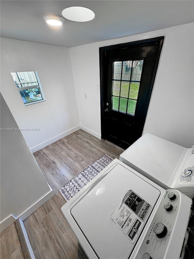 interior space featuring light wood-type flooring and washing machine and clothes dryer