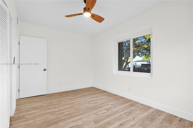 spare room featuring light hardwood / wood-style floors and ceiling fan