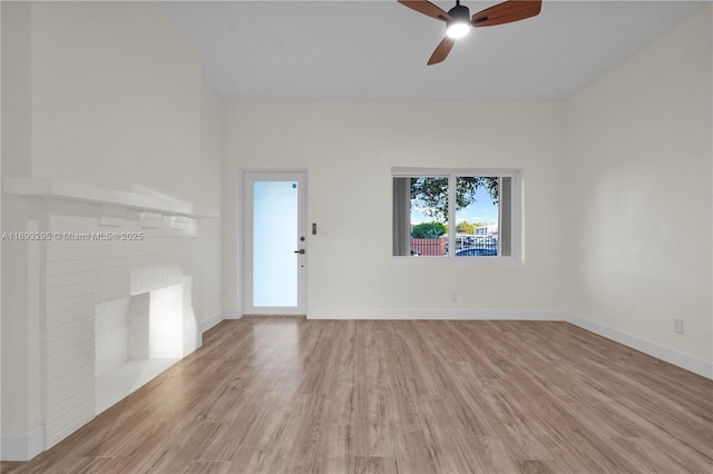 spare room featuring baseboards, wood finished floors, and a ceiling fan
