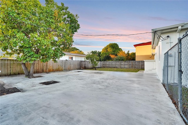 patio terrace at dusk with a fenced backyard